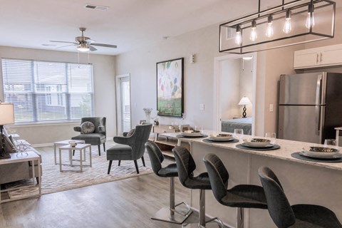 an open living room and kitchen with a dining room table and chairs